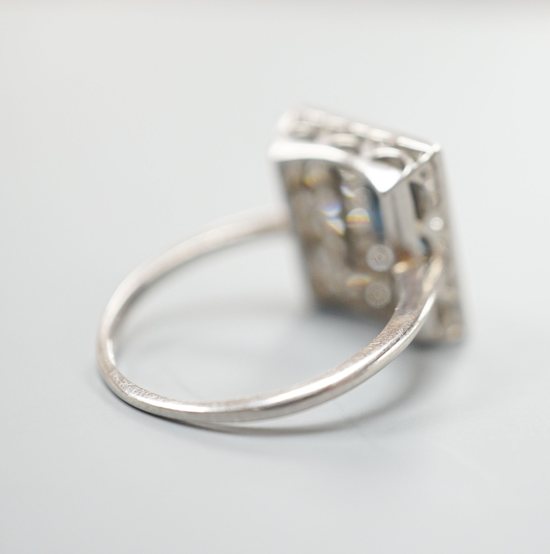 A white metal, sapphire and diamond set square cluster ring, size N, gross weight 4.2 grams.